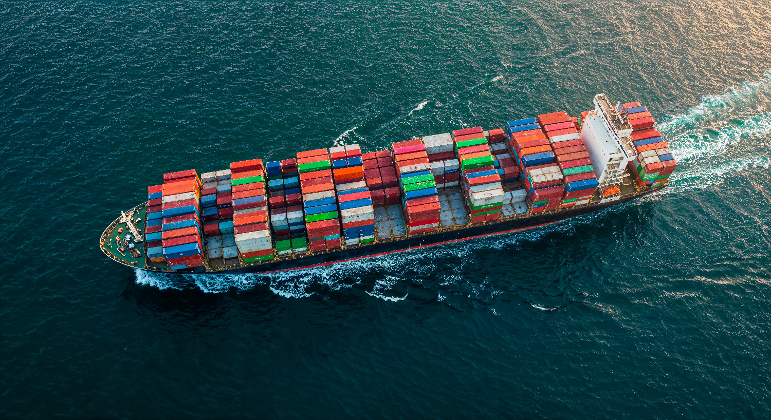 A container ship at sea, carrying stock towards the UK