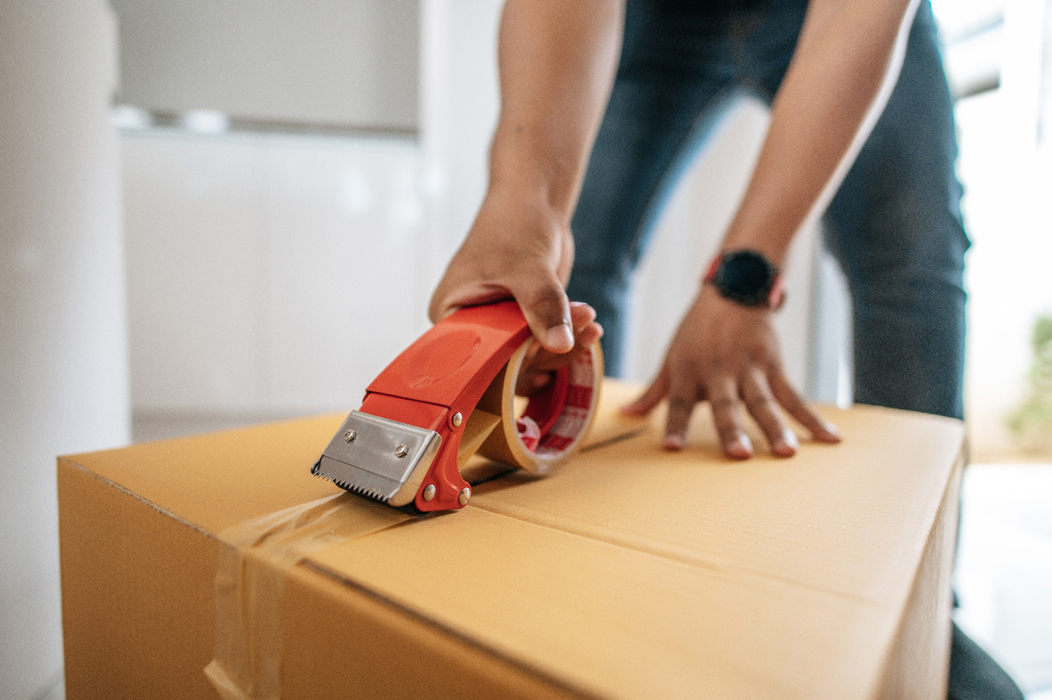 An order being taped and sealed at the packing bench